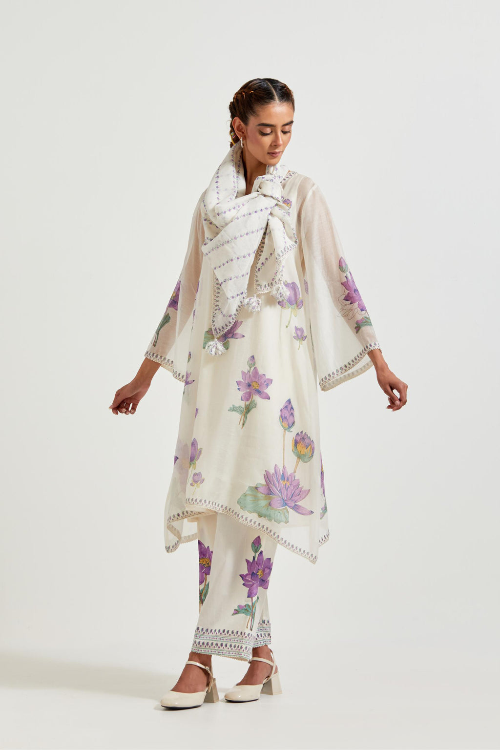 Off white cotton chanderi A-line kurta set features with all-over purple and green lotus flower hand block print.