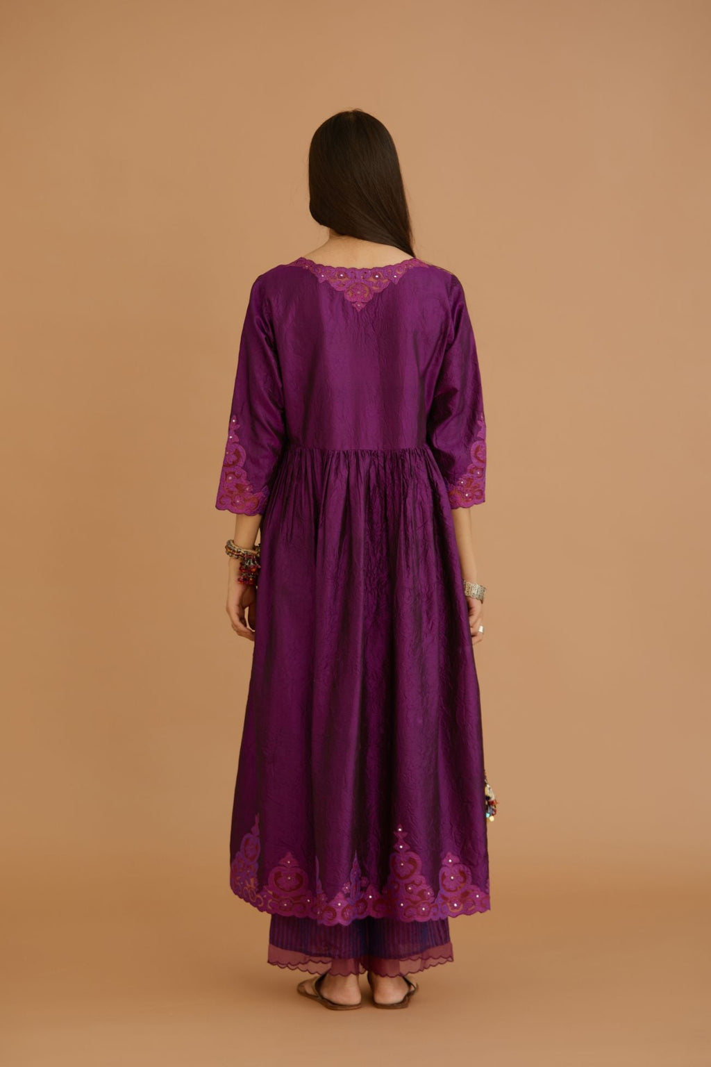 Purple hand crushed silk kurta with wavy empire waistline and gathers, with silk and organza cutwork embroidery, highlighted with hand attached mirrors.