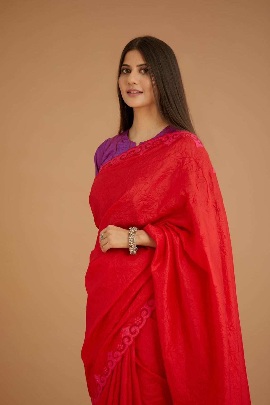Red hand crushed silk saree set, paired with purple hand crushed silk blouse with vertical inset stripe organza fabric detailing in front, back and sleeves, highlighted with contrasting top stitch.