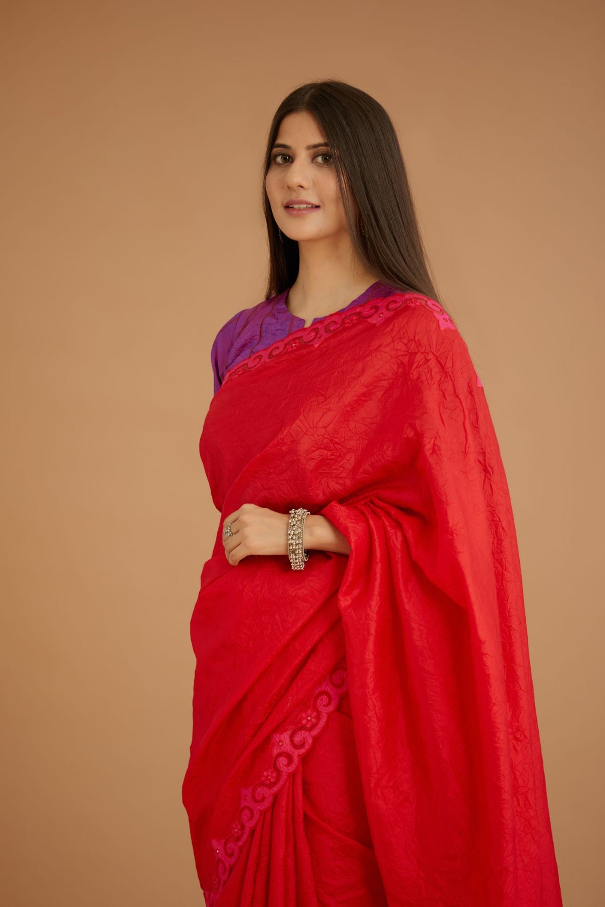 Red hand crushed silk saree set, paired with purple hand crushed silk blouse with vertical inset stripe organza fabric detailing in front, back and sleeves, highlighted with contrasting top stitch.