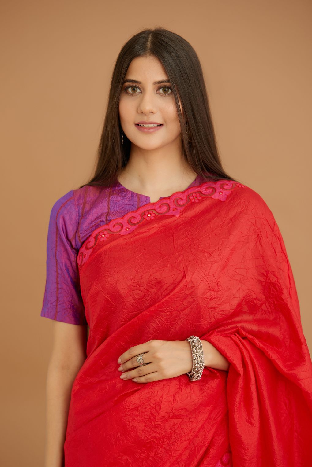 Red hand crushed silk saree set, paired with purple hand crushed silk blouse with vertical inset stripe organza fabric detailing in front, back and sleeves, highlighted with contrasting top stitch.