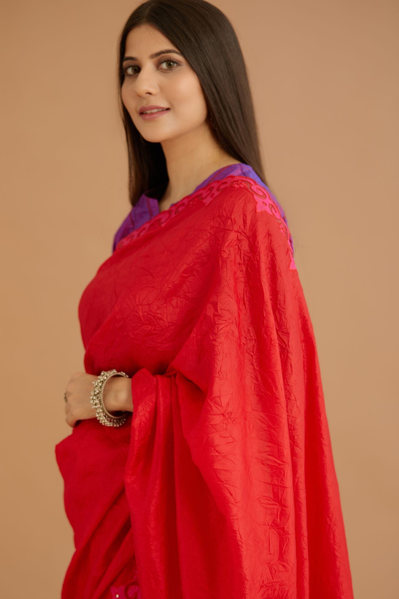 Red hand crushed silk saree set, paired with purple hand crushed silk blouse with vertical inset stripe organza fabric detailing in front, back and sleeves, highlighted with contrasting top stitch.