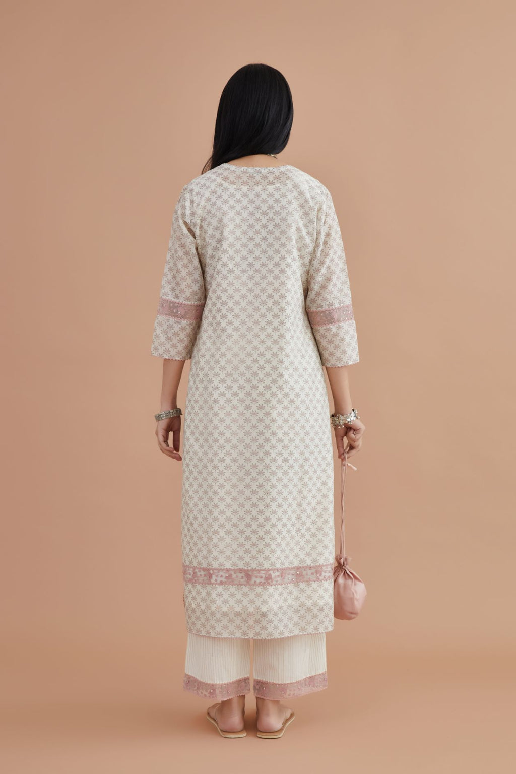 Off white silk chanderi kurta set with pink lotus hand block print, highlighted with pink thread embroidery inset and rickrack lace.