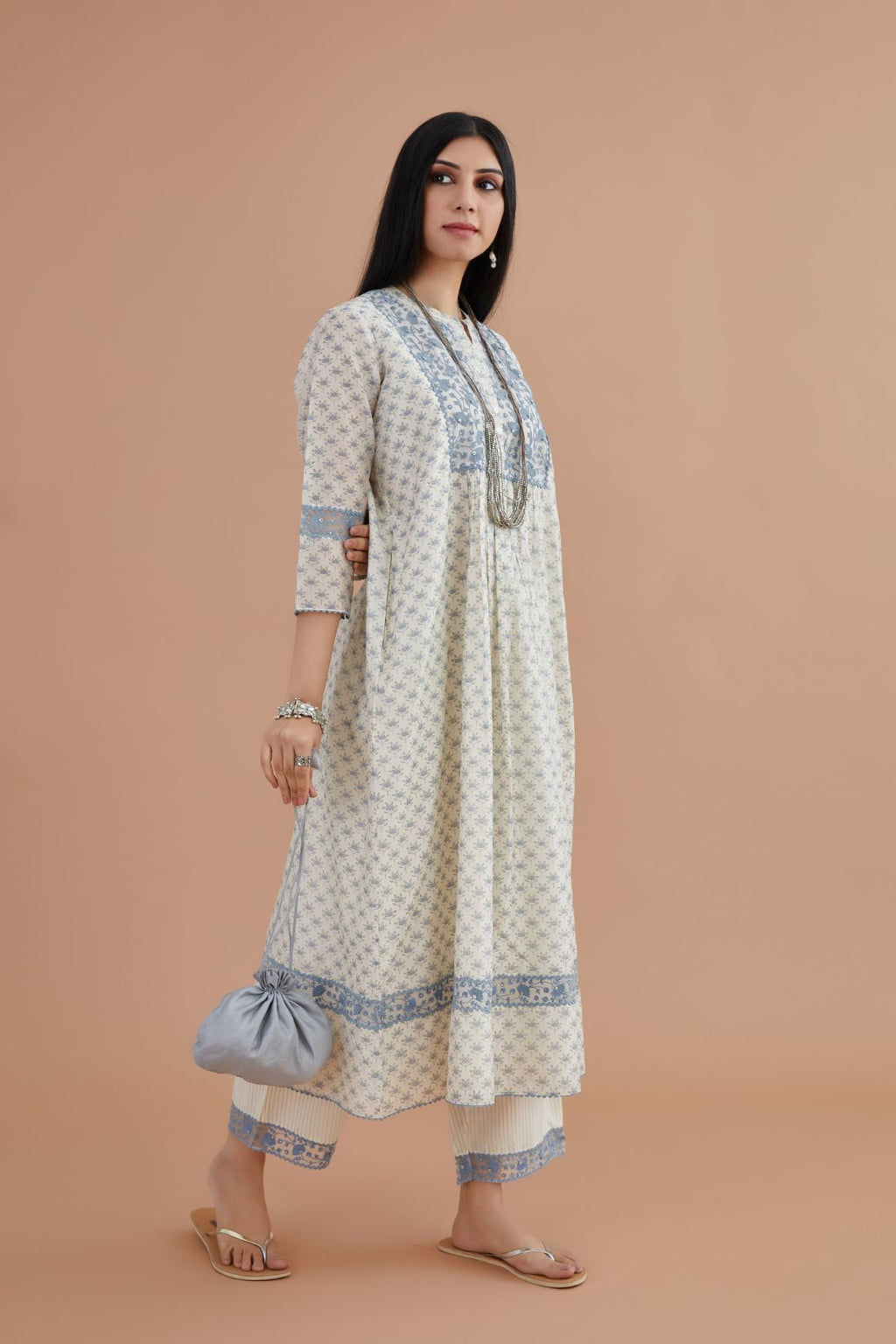 Silk Chanderi kurta set with all-over blue lotus hand block print and embroidered yoke with fine gathers at waist.