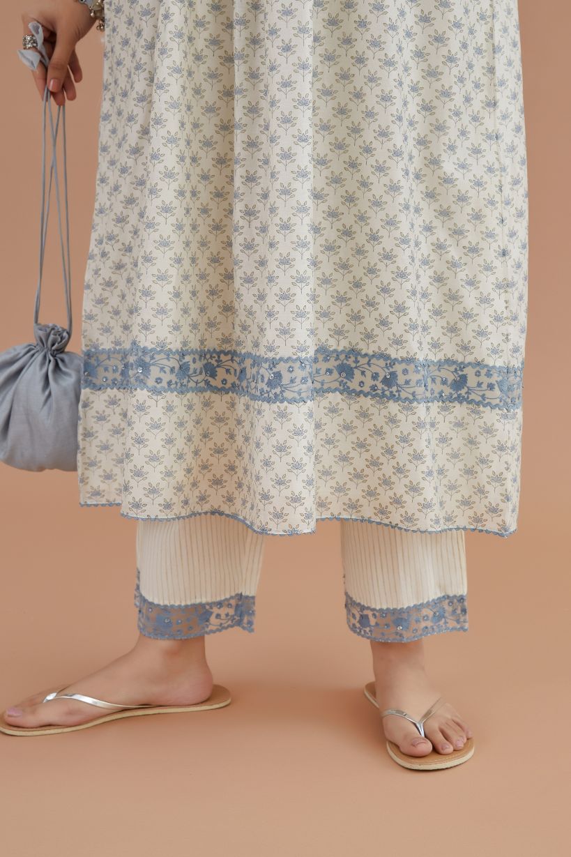 Silk Chanderi kurta set with all-over blue lotus hand block print and embroidered yoke with fine gathers at waist.