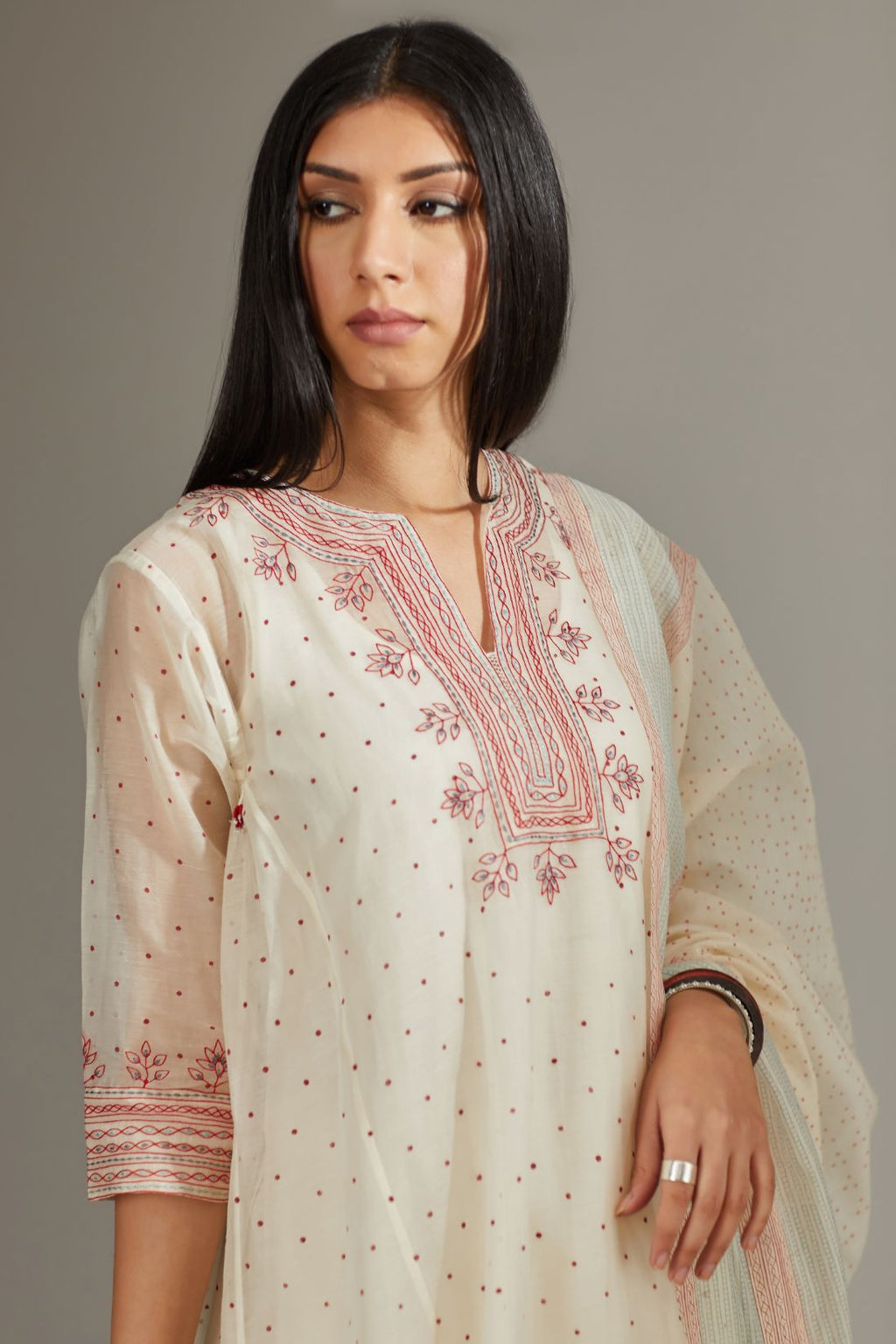 Asymmetric hand block printed kurta set with contrast quilted embroidery.