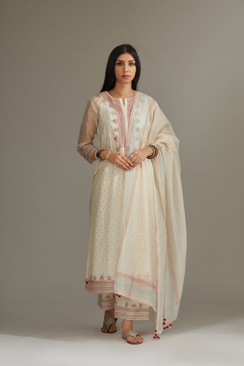 Straight kurta set with all-over hand block print and side panels highlighted with quilted embroidery.