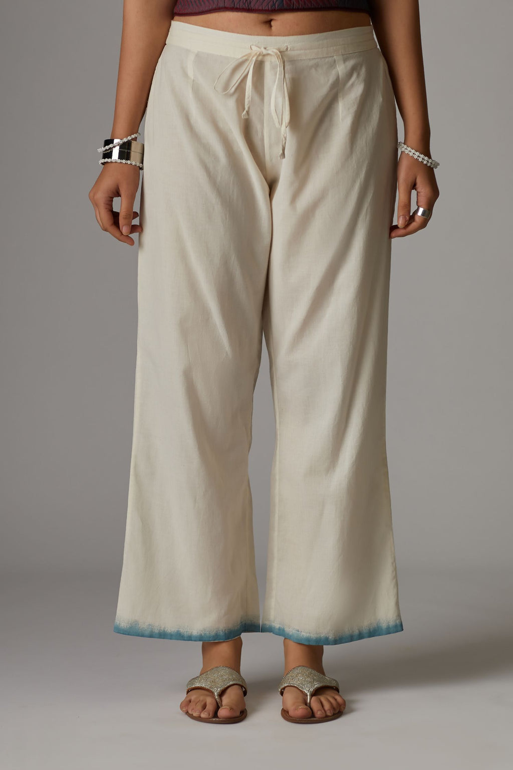 Off white straight pants with hand block print at the bottom