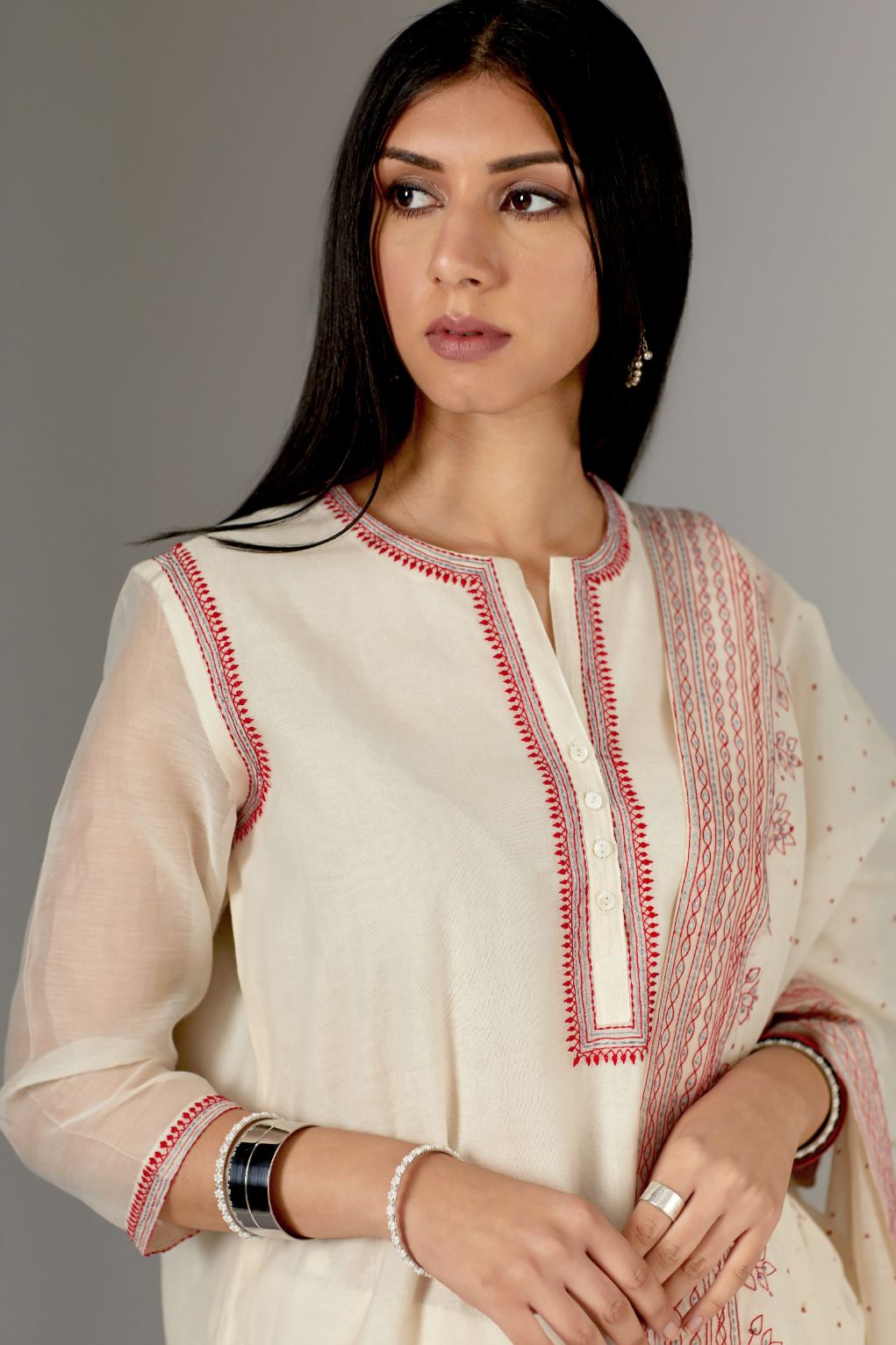 Straight Kurta set detailed with fine contrast thread embroidery.