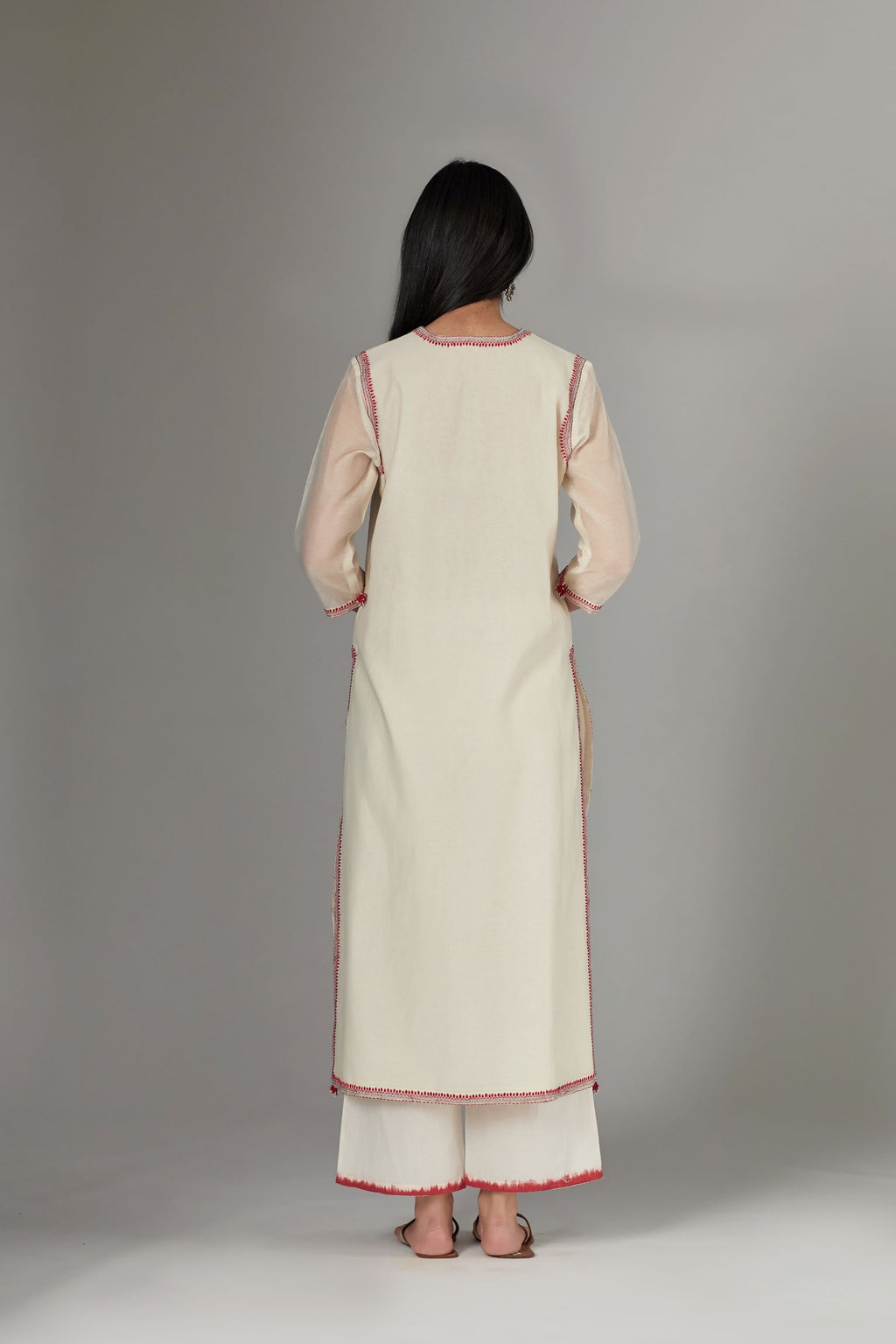 Straight Kurta set detailed with fine contrast thread embroidery.