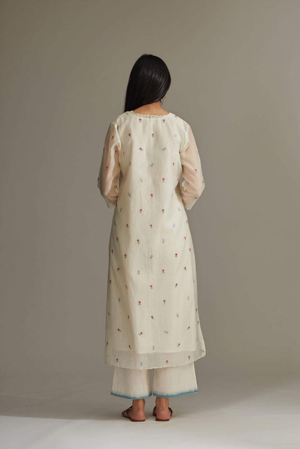 Straight Kurta set detailed with all-over multi colored small floral embroidery.