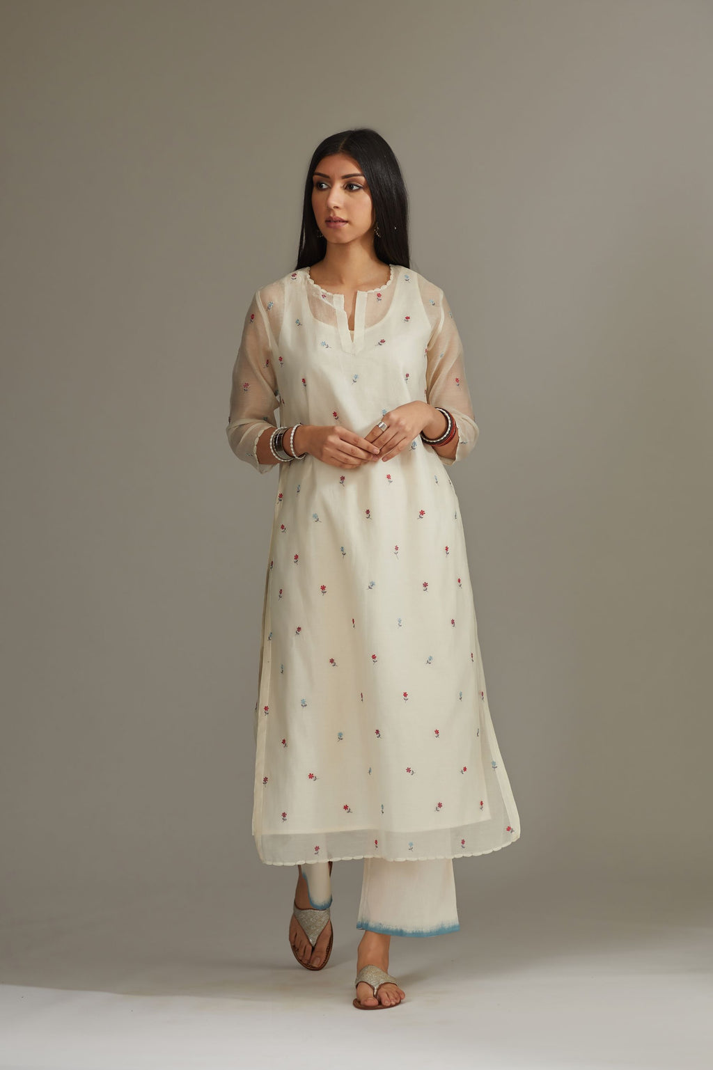 Straight Kurta set detailed with all-over multi colored small floral embroidery.