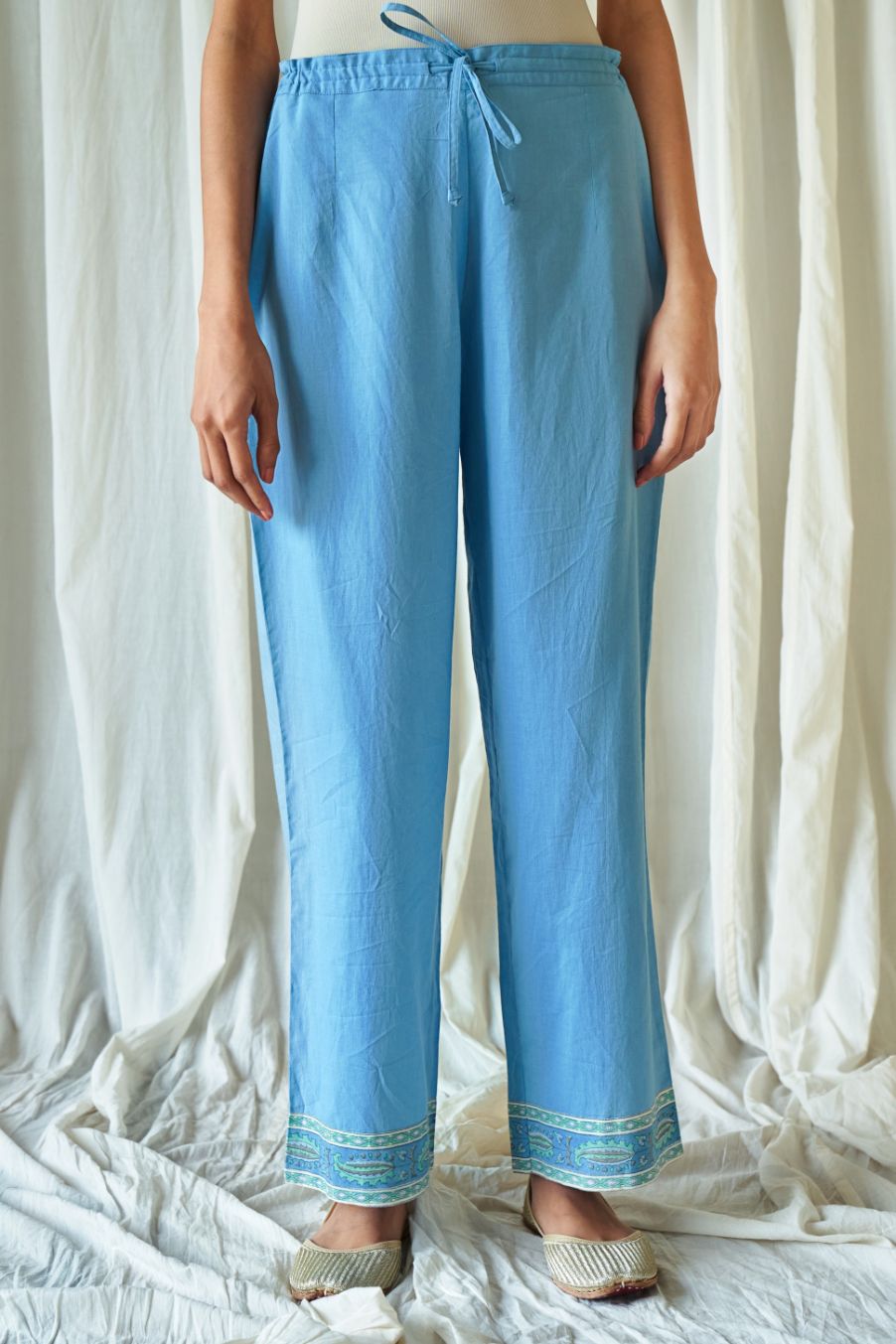 Blue straight cotton pants with hand block print at hem