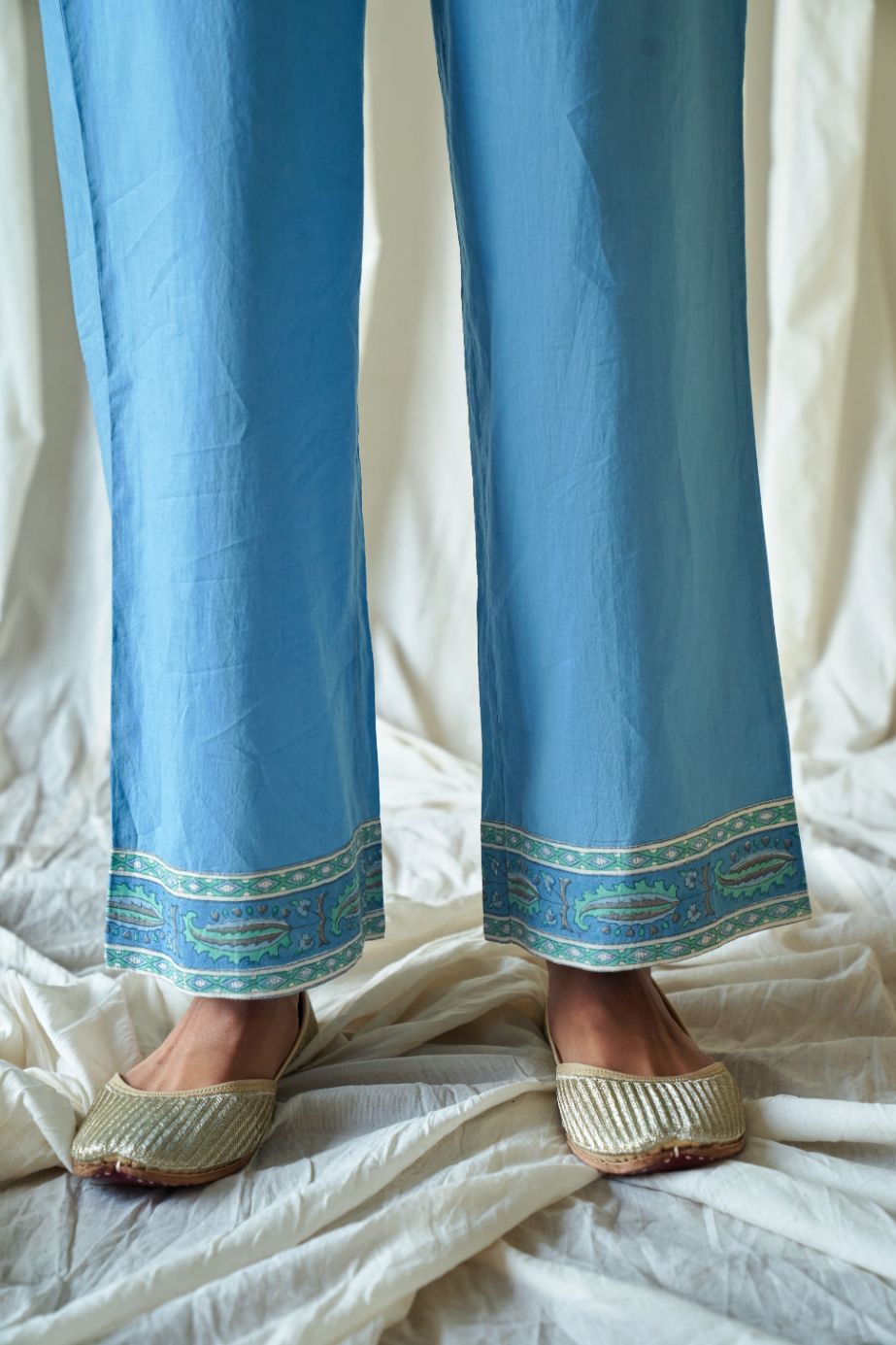 Blue straight cotton pants with hand block print at hem