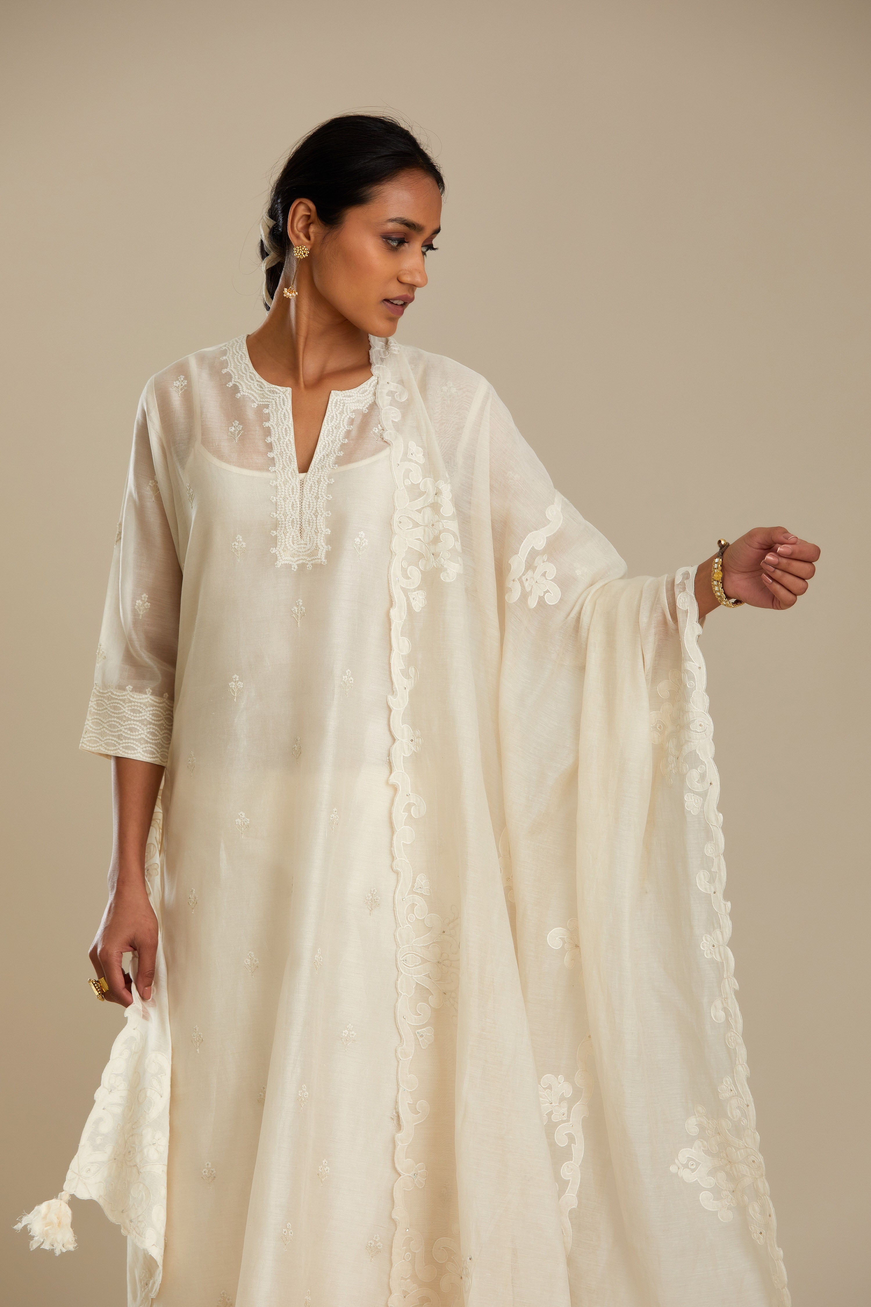 Off white cotton chanderi dupatta with cotton appliqué embroidery and sequin detail. (Dupatta)