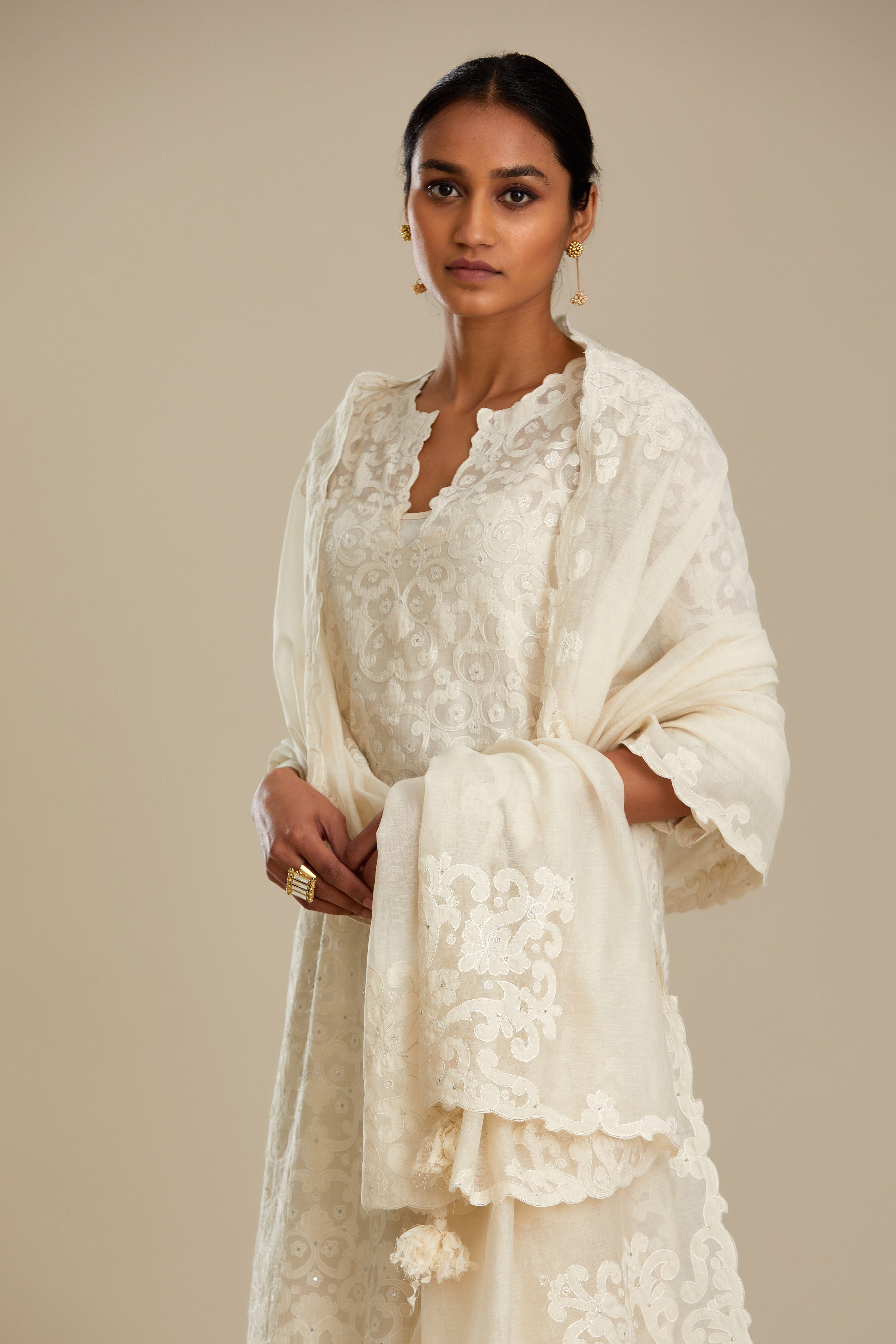 Off white cotton chanderi dupatta with cotton appliqué embroidery and sequin detail. (Dupatta)