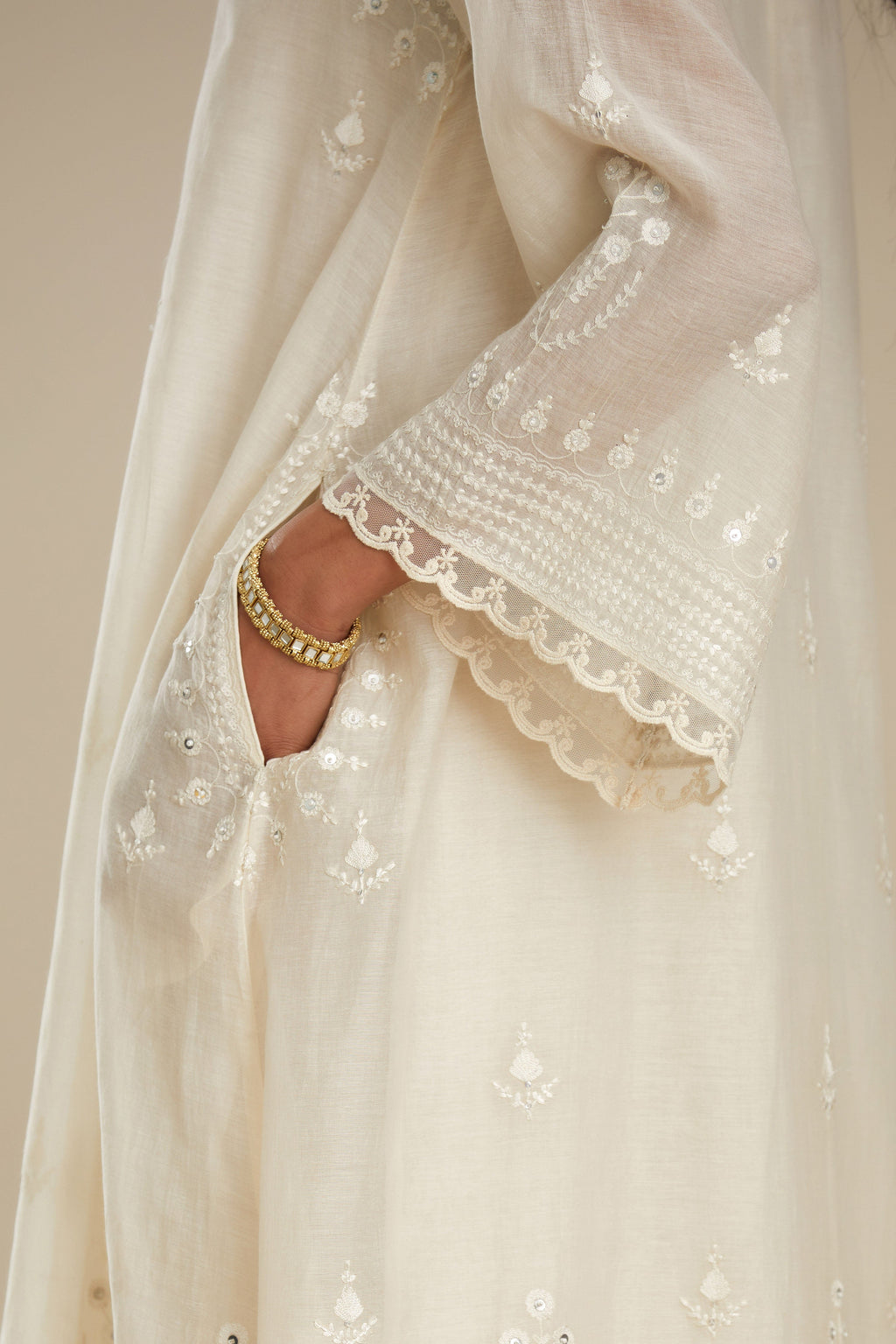 Cotton chanderi easy fit short V neck kurta set with tonal silk thread embroidery, highlighted with sequin and beads.