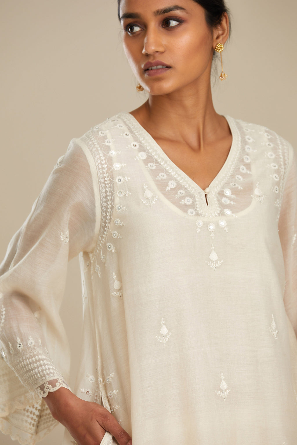Cotton chanderi easy fit short V neck kurta set with tonal silk thread embroidery, highlighted with sequin and beads.