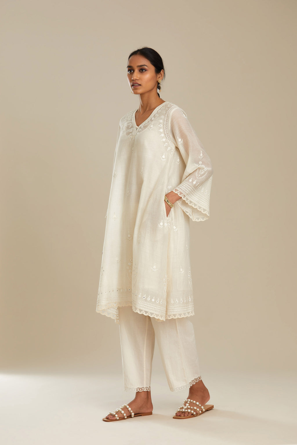 Cotton chanderi easy fit short V neck kurta set with tonal silk thread embroidery, highlighted with sequin and beads.