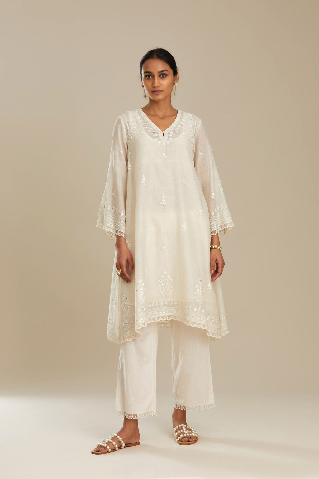 Cotton chanderi easy fit short V neck kurta set with tonal silk thread embroidery, highlighted with sequin and beads.