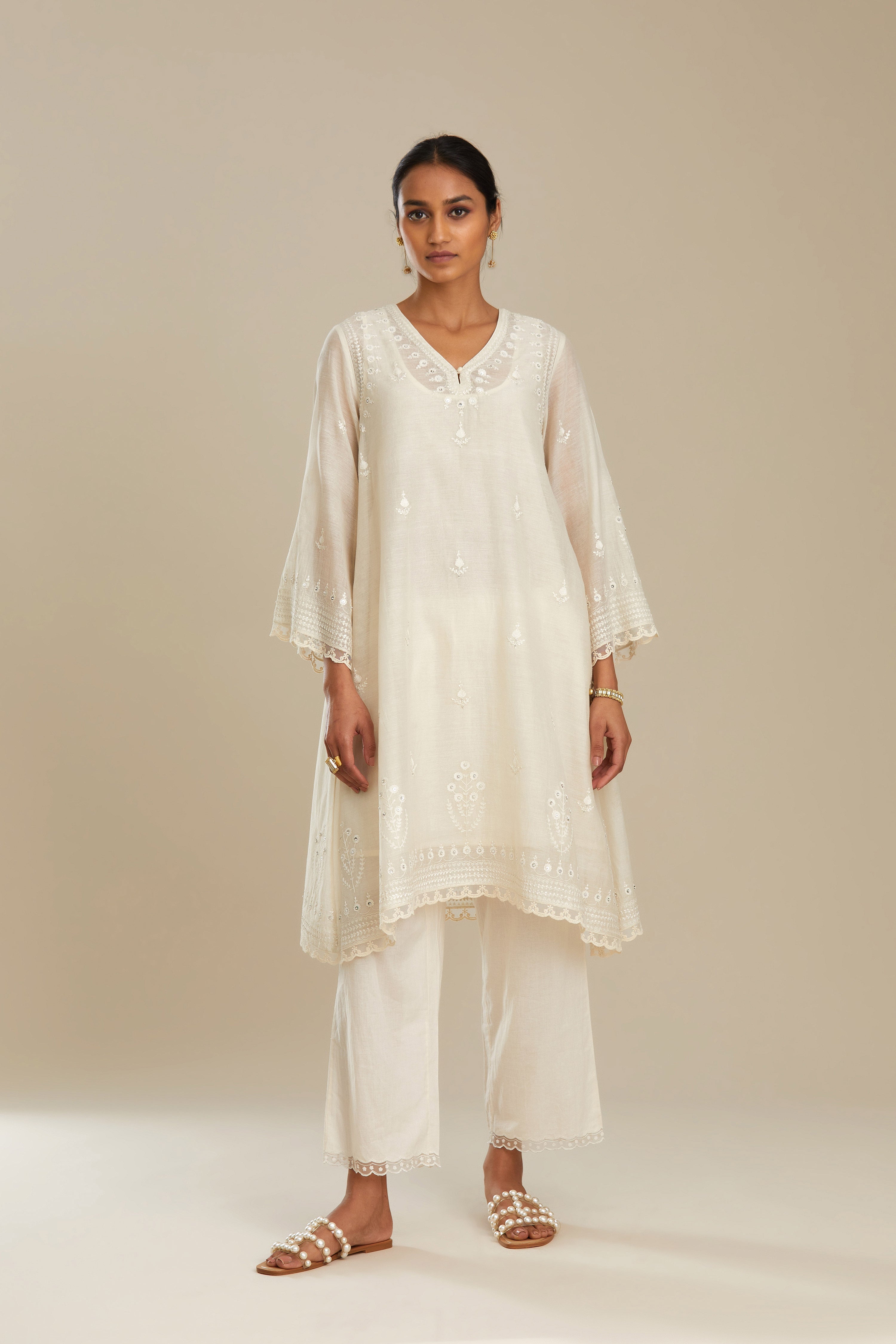Cotton chanderi easy fit short V neck kurta set with tonal silk thread embroidery, highlighted with sequin and beads.