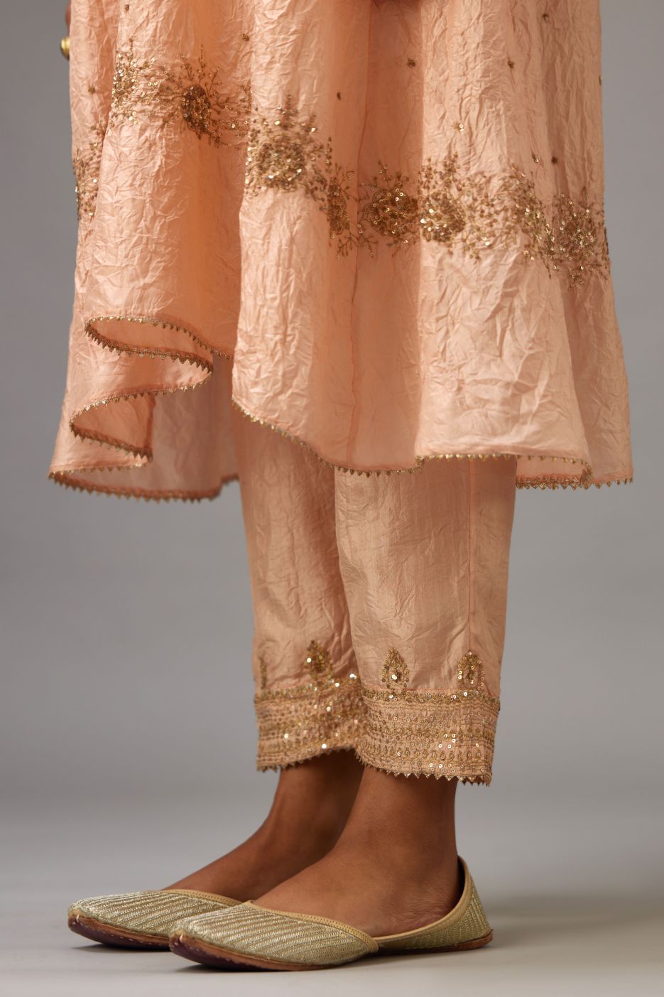 Hand crushed silk short kurta set with golden sequins work at neck and hem.