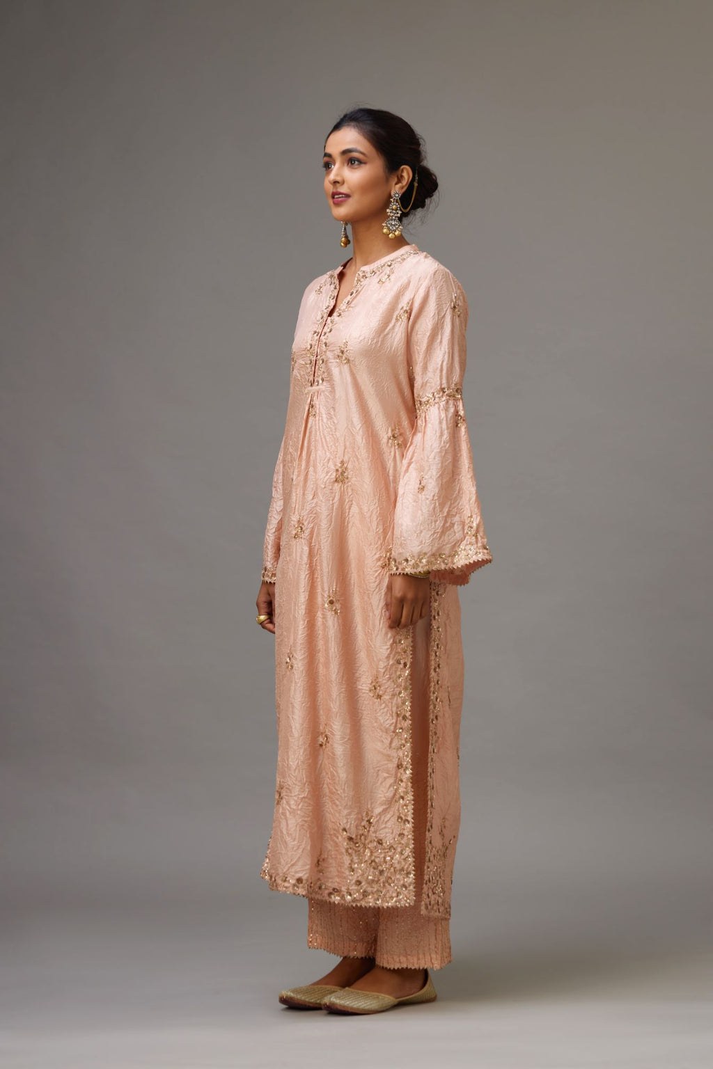 Pink hand crushed silk straight kurta set with all-over gold sequins and zari handwork, highlighted with gota lace at edges.