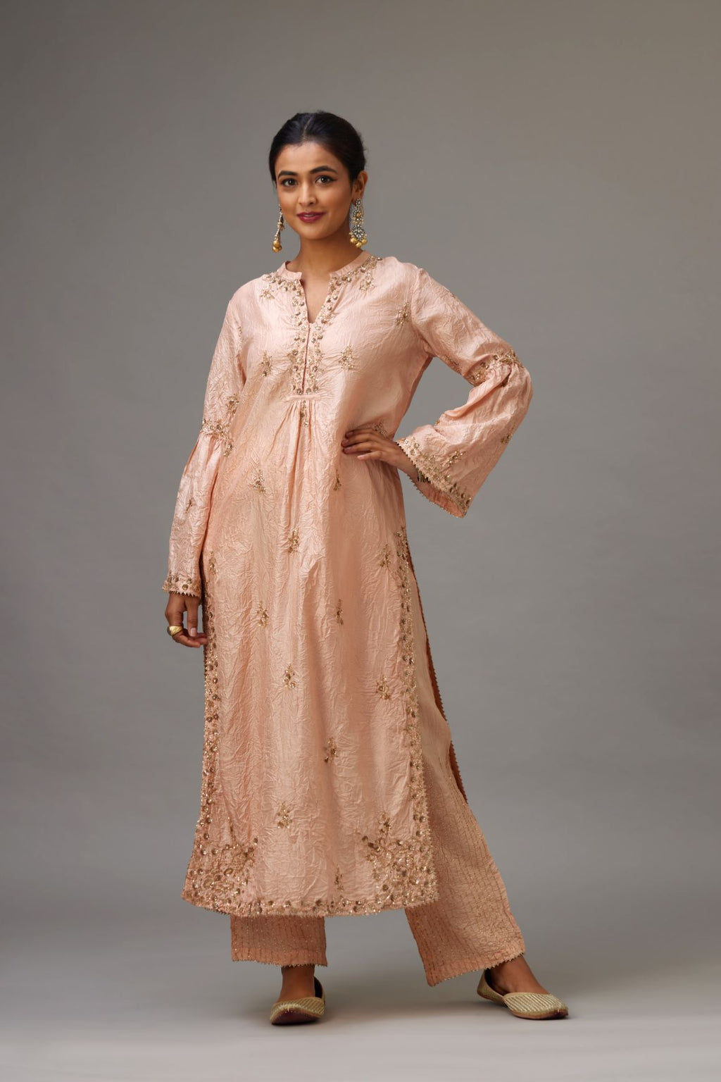 Pink hand crushed silk straight kurta set with all-over gold sequins and zari handwork, highlighted with gota lace at edges.