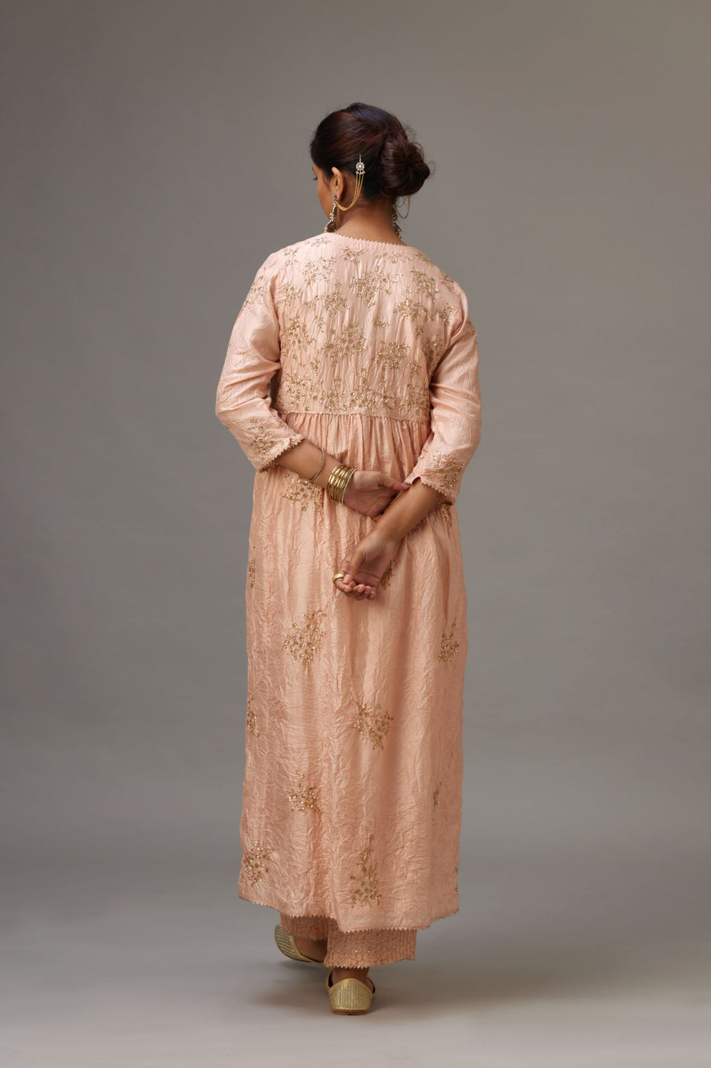 Pink silk hand crushed V neck gathered kurta set, highlighted with all-over gold sequins boota.