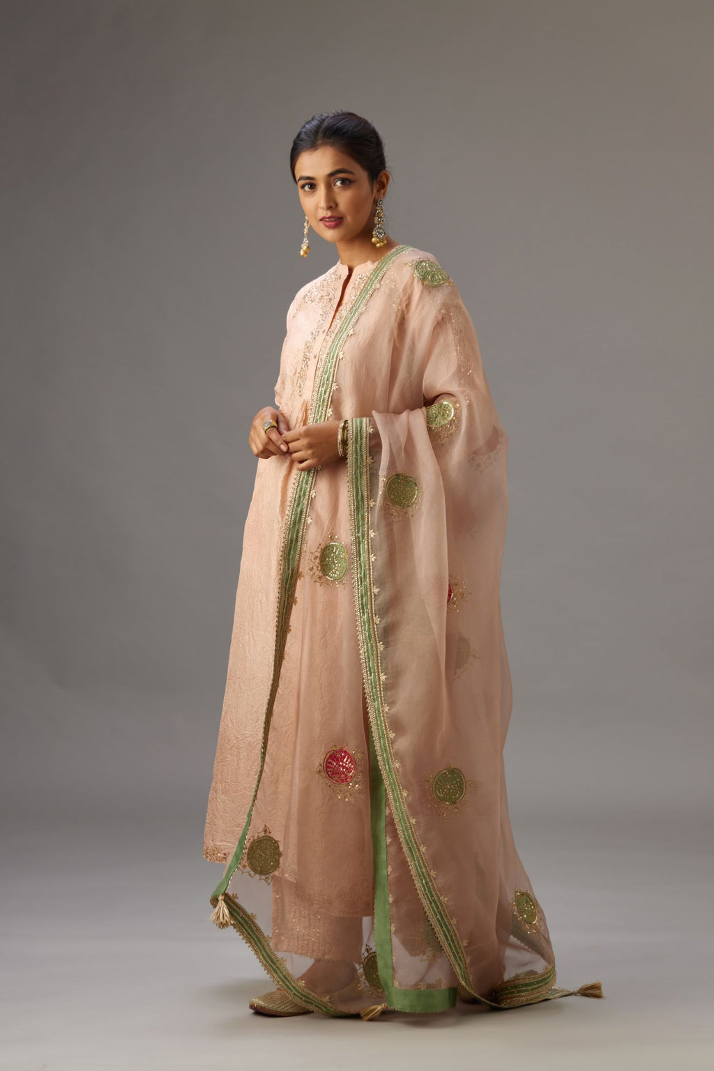 Pink silk hand crushed kurta set with button placket neckline, highlighted with gold sequins work at hem, neck and armhole.