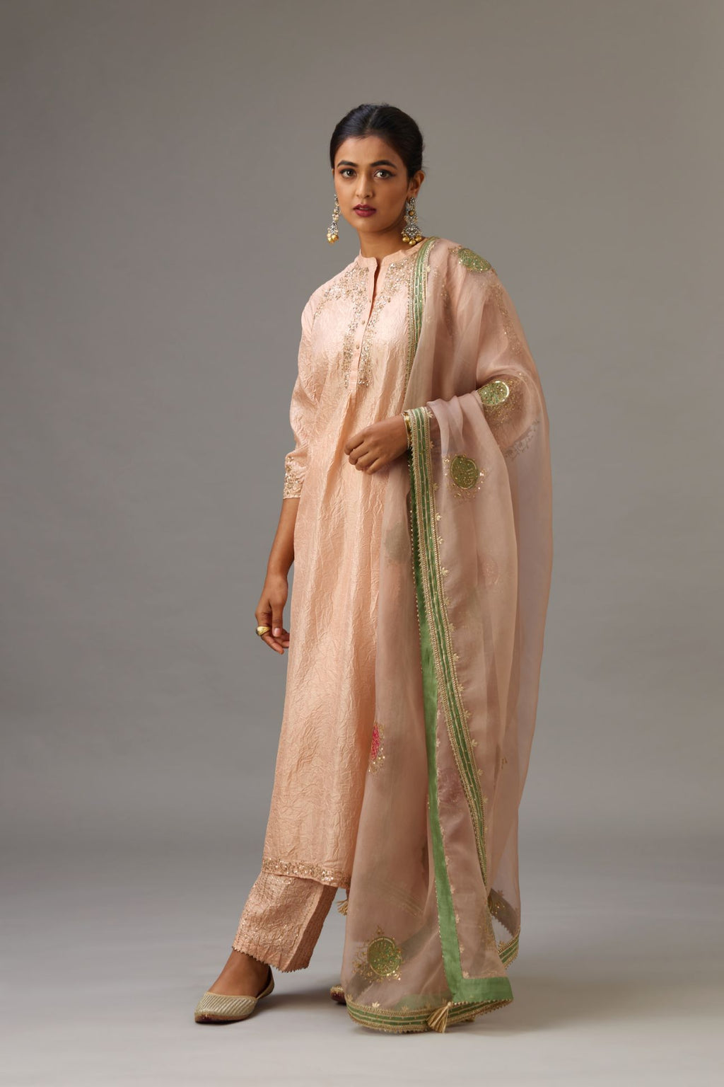 Pink silk hand crushed kurta set with button placket neckline, highlighted with gold sequins work at hem, neck and armhole.