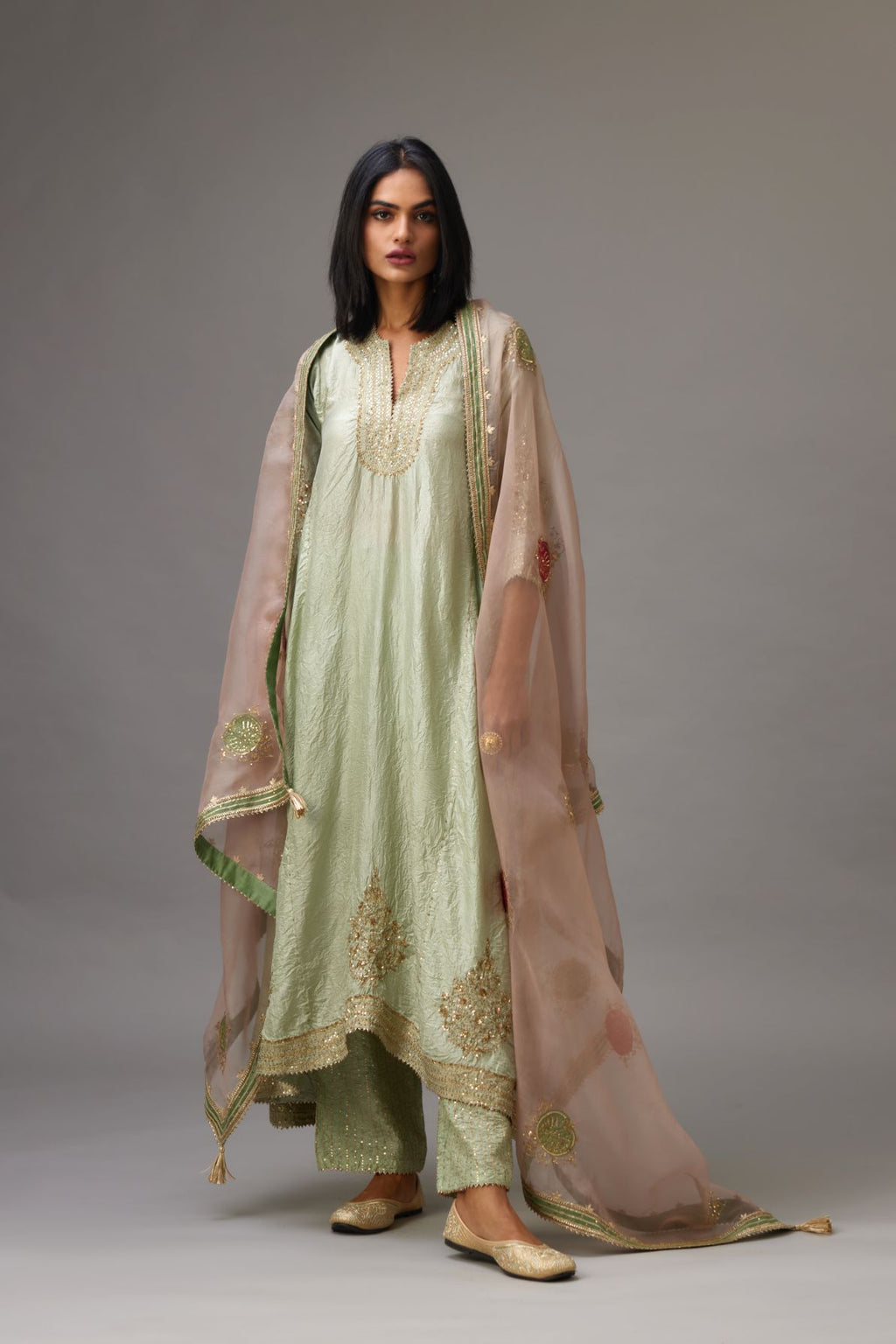 Green silk hand crushed easy fit kurta set with golden sequins bootas at hem.