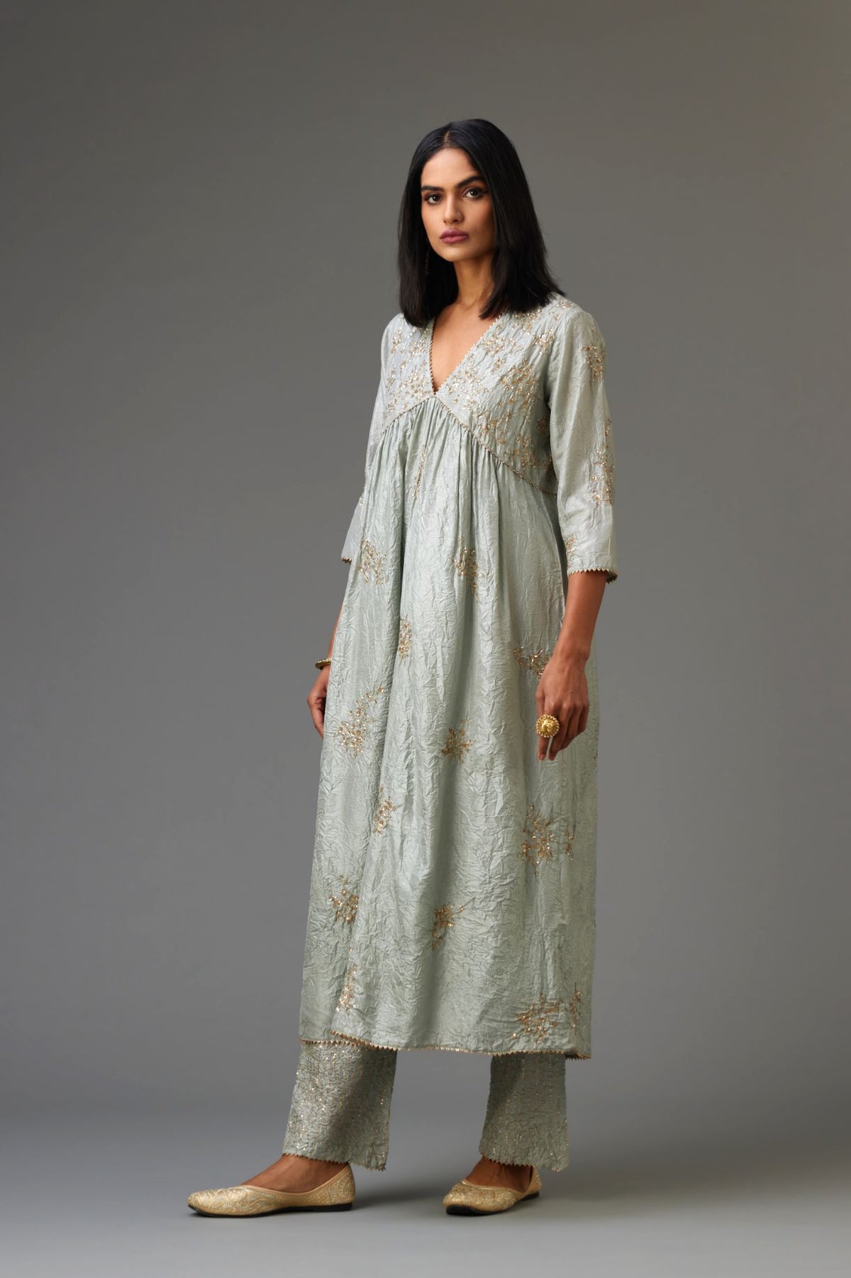 Blue silk hand crushed V neck gathered kurta set, highlighted with all-over gold sequins boota.