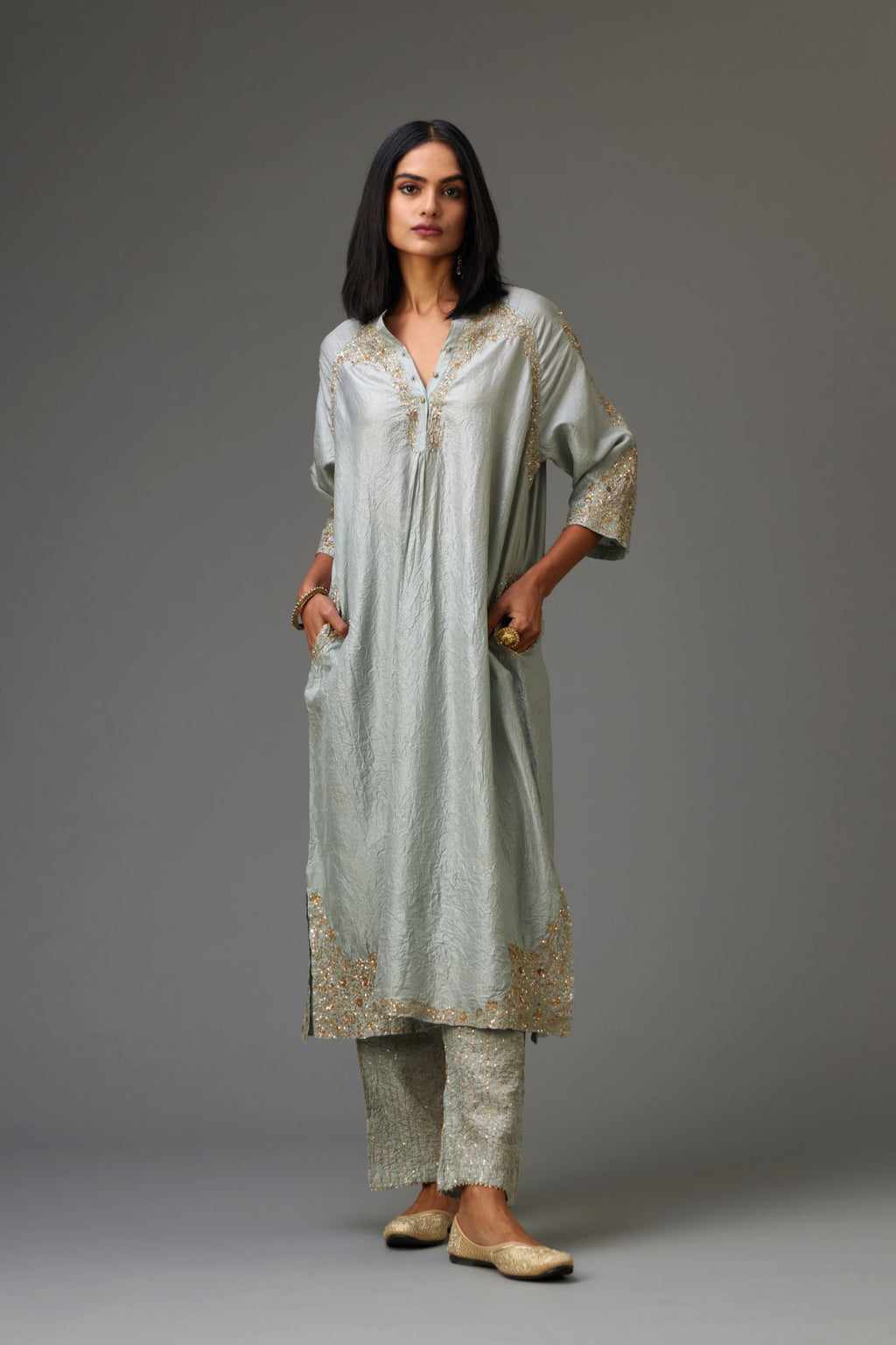Blue silk hand crushed kurta set with button placket neckline, highlighted with gold sequins work at hem, neck and armhole.