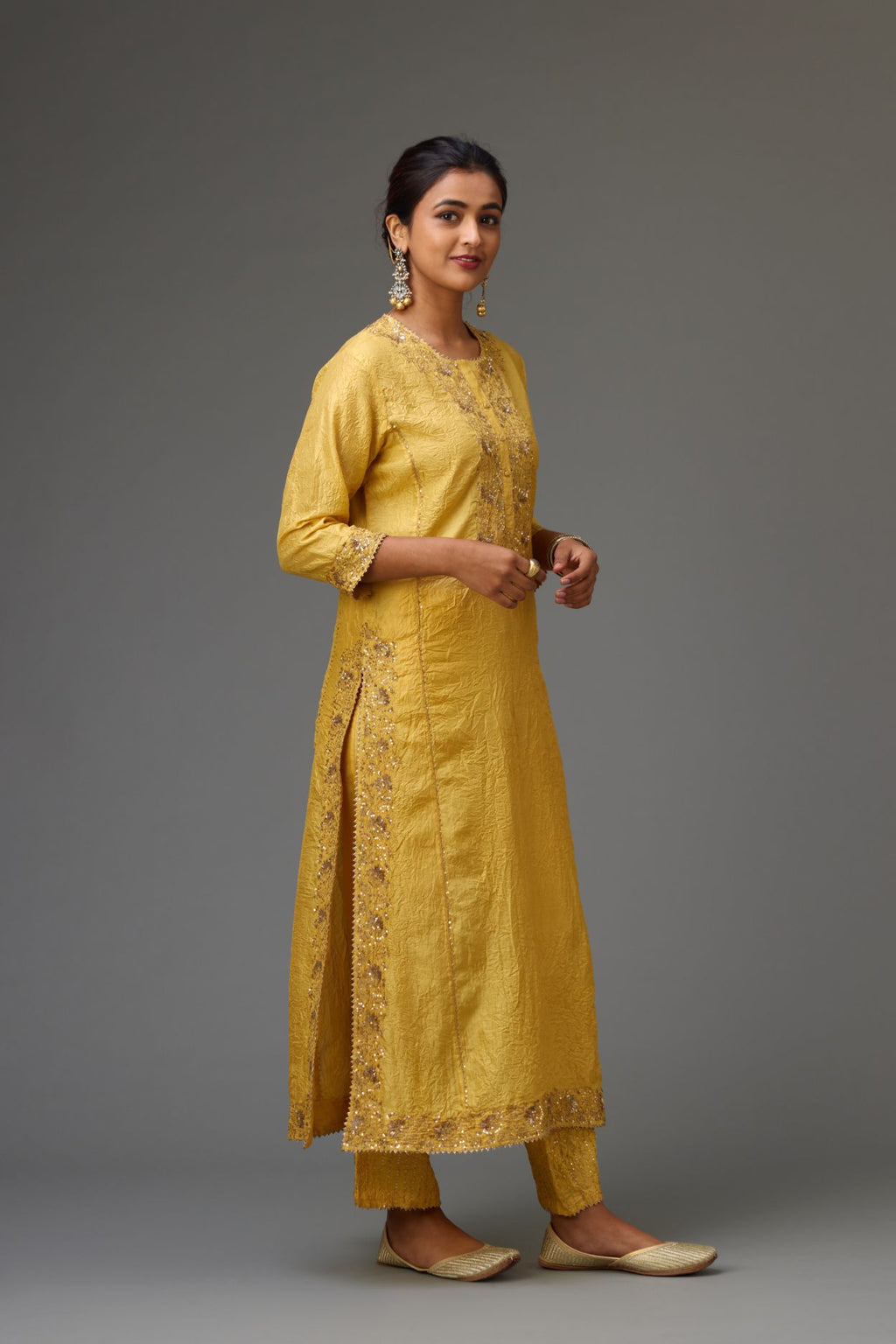 Yellow hand crushed kalidar straight kurta set with gold sequins and zari handwork.
