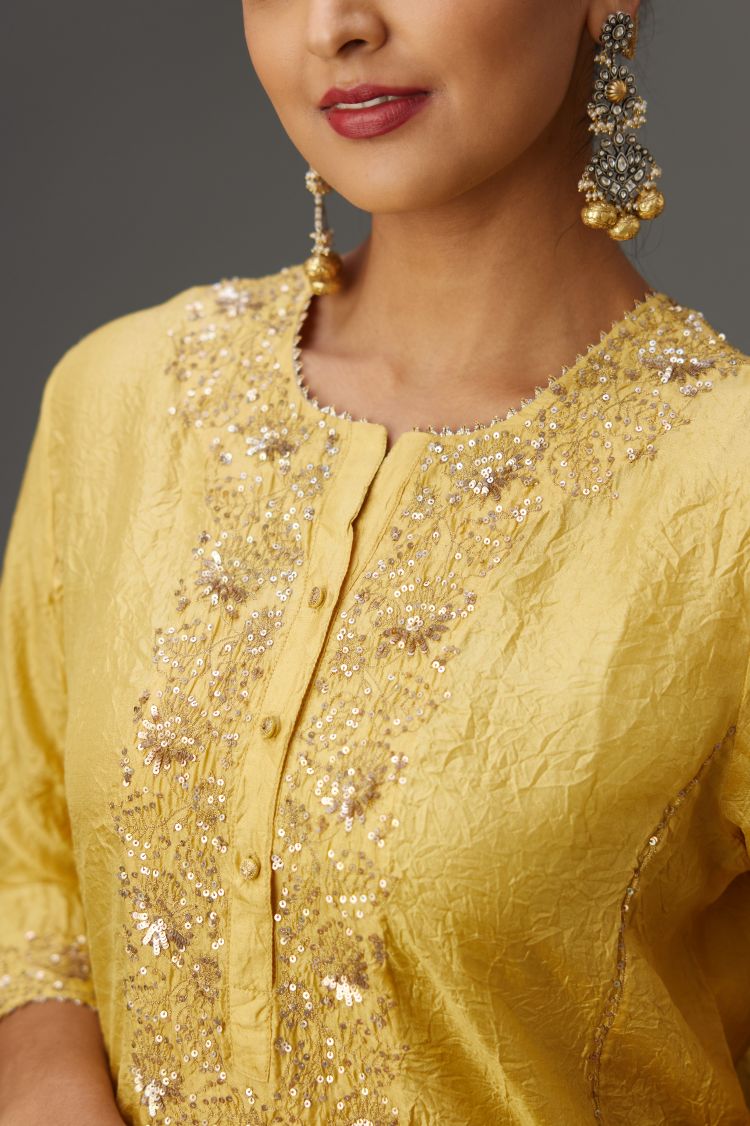 Yellow hand crushed kalidar straight kurta set with gold sequins and zari handwork.