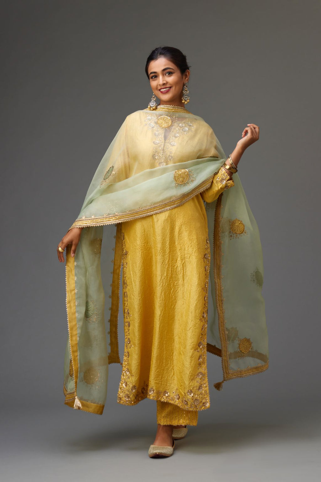 Yellow hand crushed silk straight kurta set highlighted with gold sequins and zari handwork.