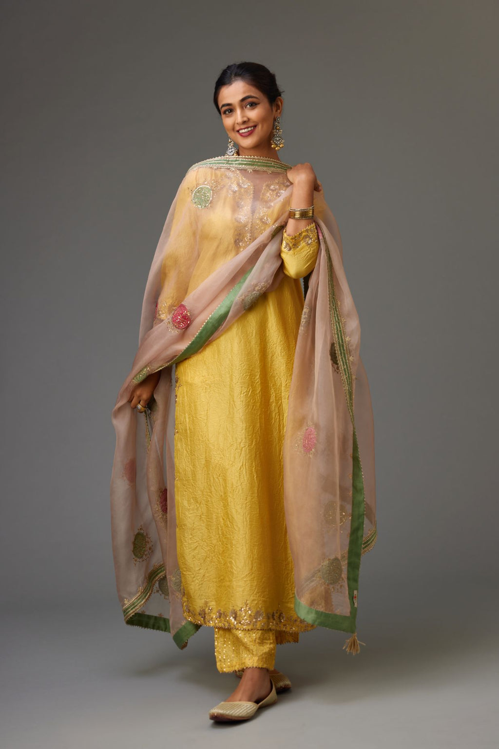 Yellow hand crushed silk straight kurta set highlighted with gold sequins and zari handwork.