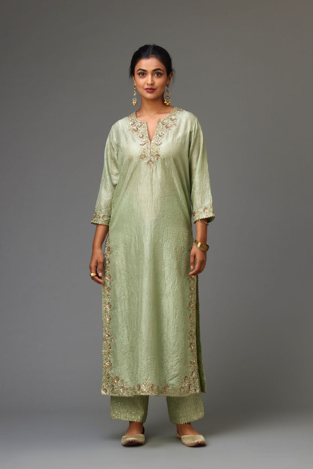 Green hand crushed silk straight kurta set highlighted with gold sequins and zari handwork.