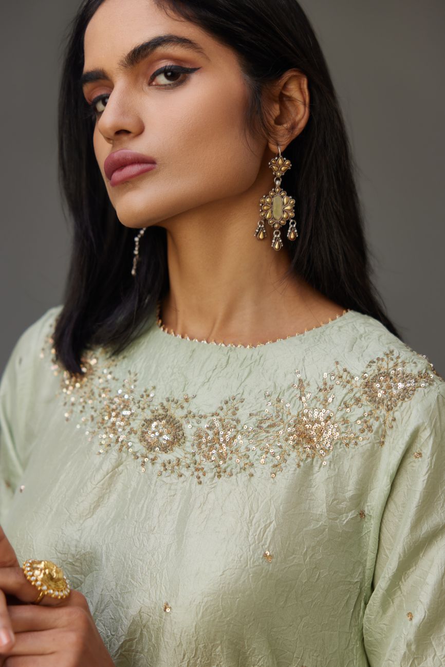 Hand crushed silk short kurta set with golden sequins work at neck and hem.