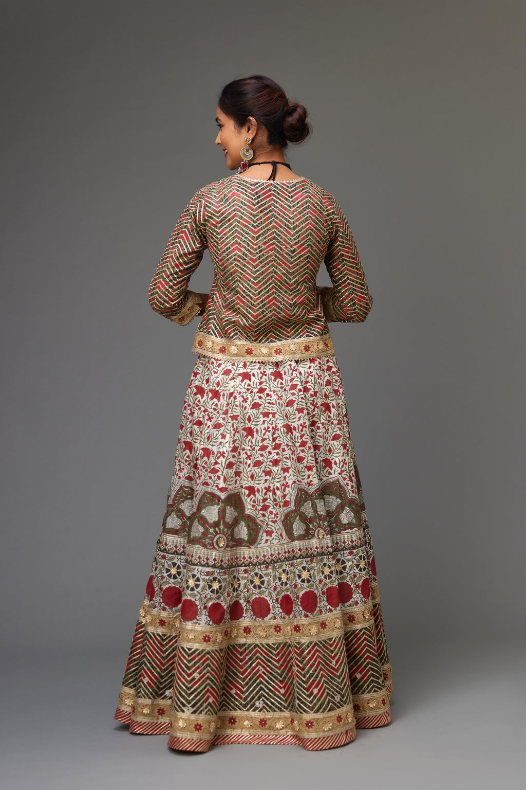 Silk chanderi hand block printed lehenga with herringbone gota embroidery at hem, along with a half 'thaal' design at the kalis, highlighted with gota flowers and gold sequins.