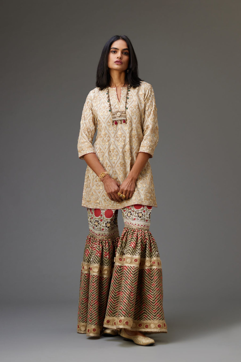 Off-white short kurta set detailed with all-over dori, sequins and gota embroidery.