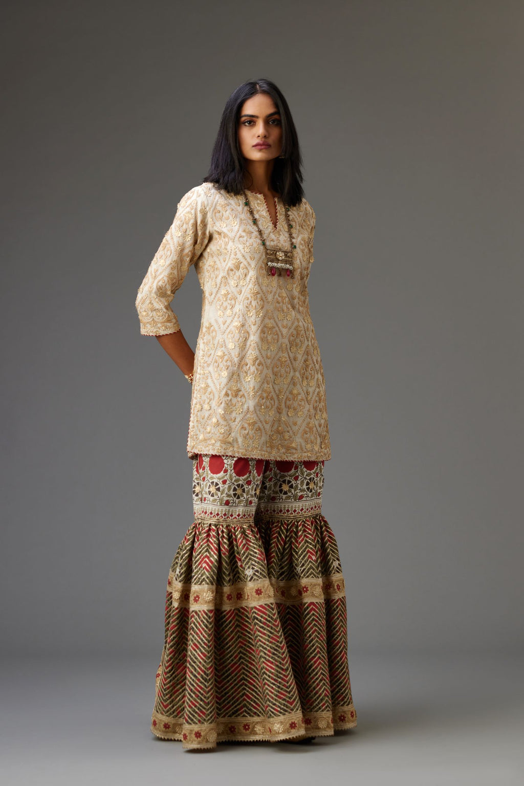 Off-white short kurta set detailed with all-over dori, sequins and gota embroidery.