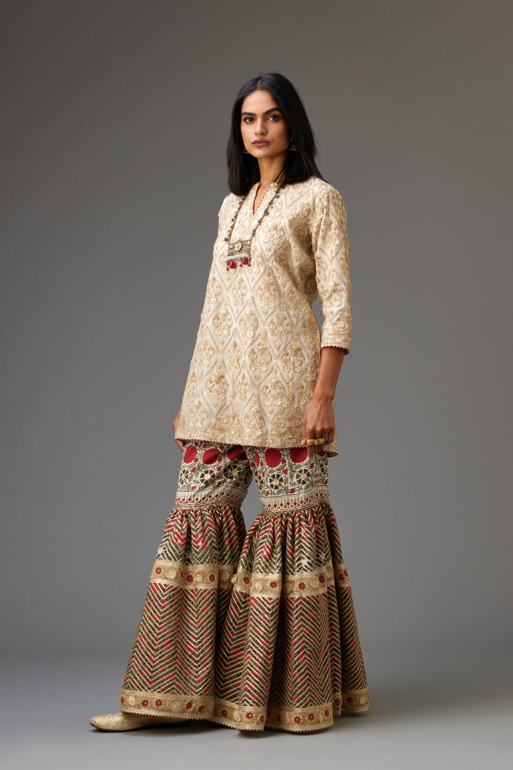 Off-white short kurta set detailed with all-over dori, sequins and gota embroidery.