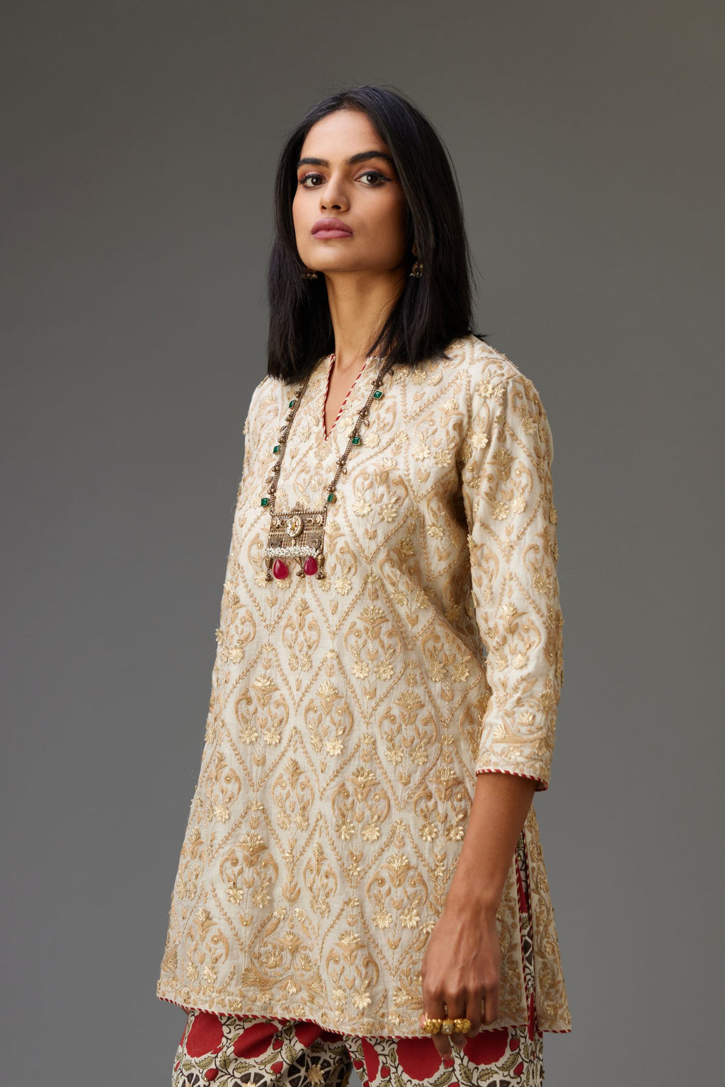 Off-white short kurta set detailed with all-over dori, sequins and gota embroidery.