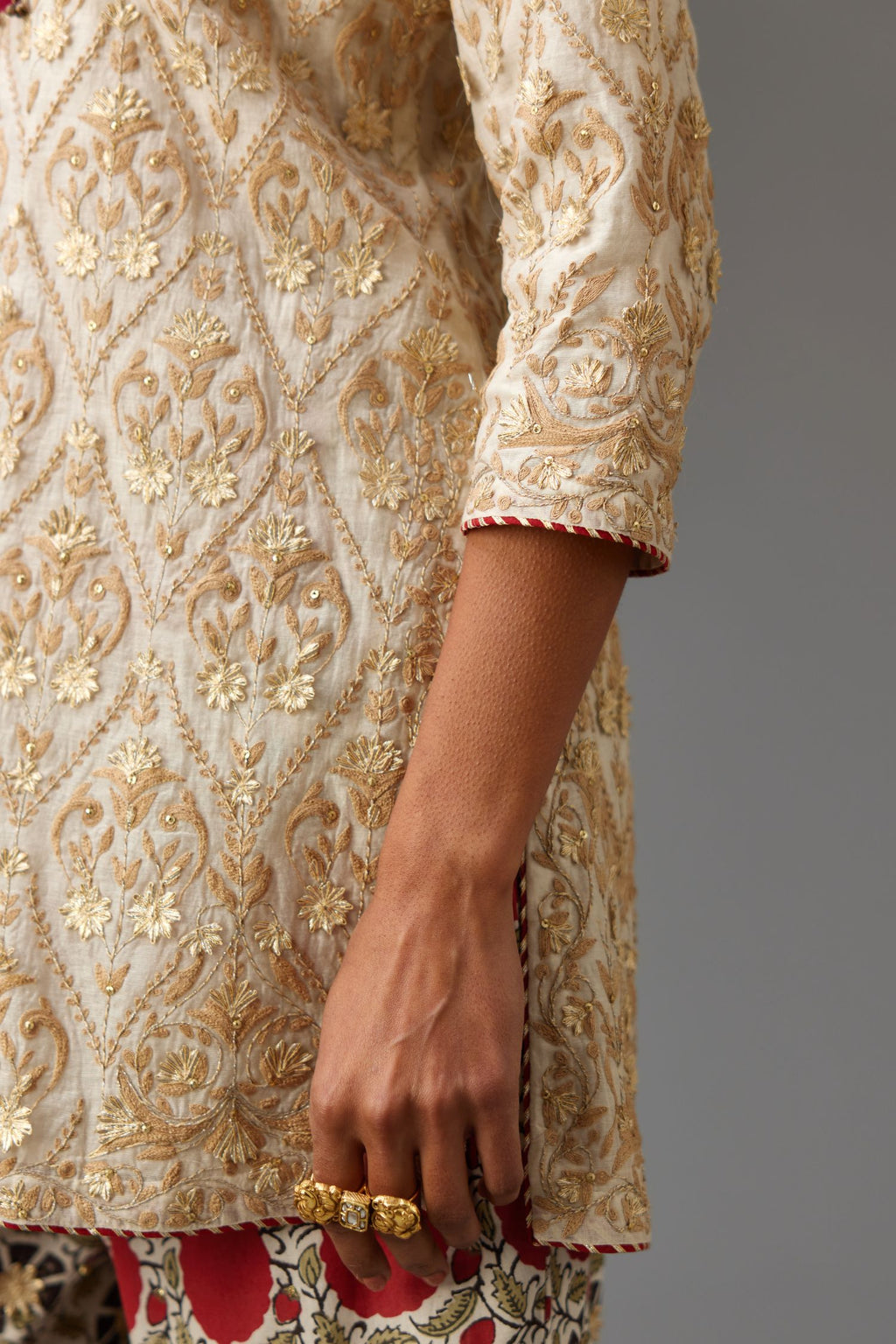 Off-white short kurta set detailed with all-over dori, sequins and gota embroidery.