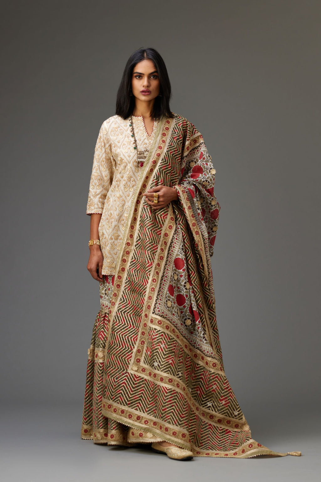 Off-white short kurta set detailed with all-over dori, sequins and gota embroidery.