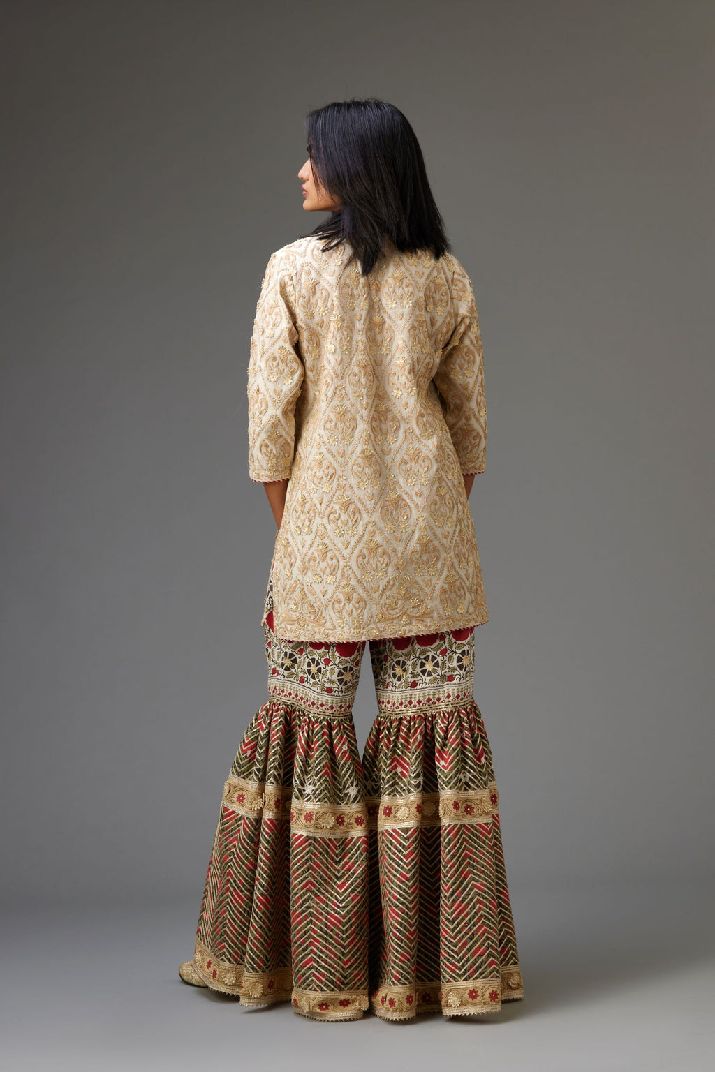 Off-white short kurta set detailed with all-over dori, sequins and gota embroidery.