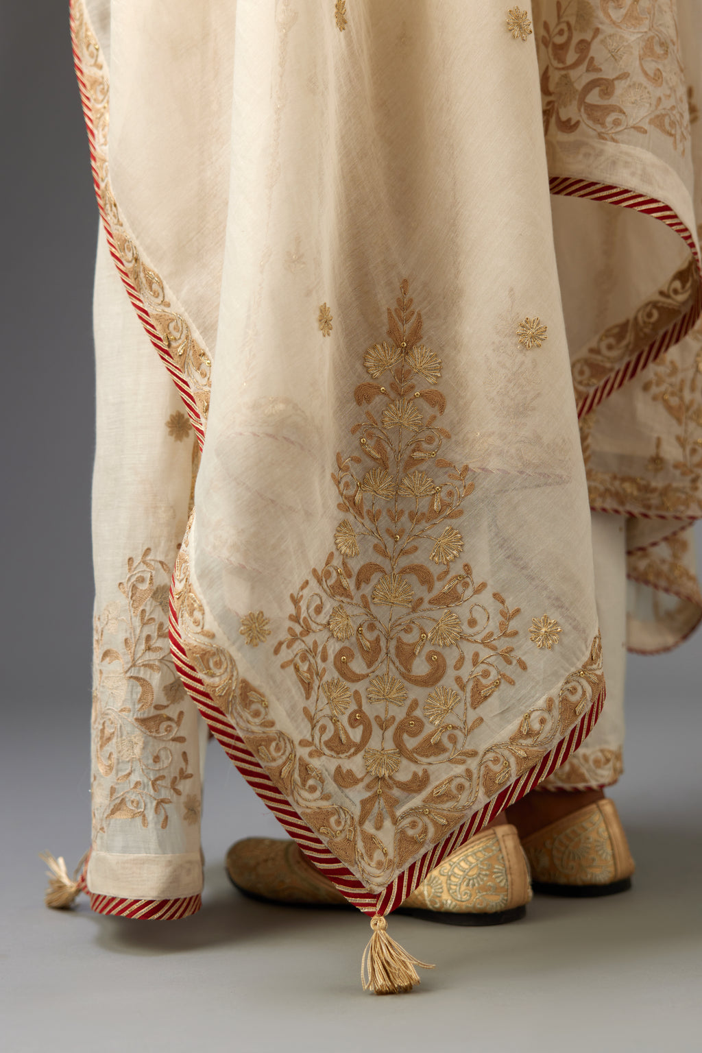 Off-white cotton chanderi dupatta with dori and gota embroidery at edges, highlighted with gold sequins.