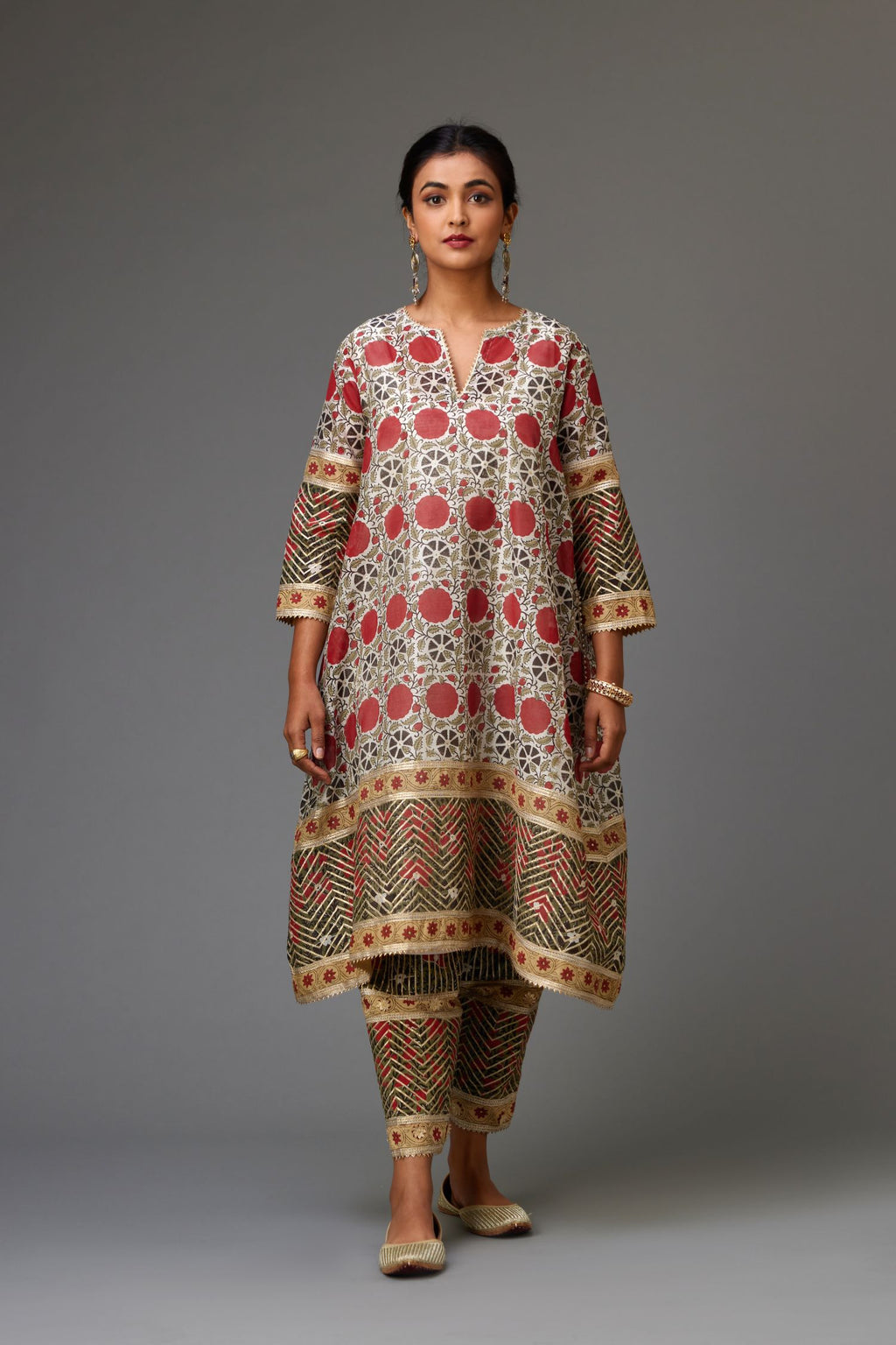Red and off white hand block printed short A-line kurta set, detailed with gold gota and flowers.